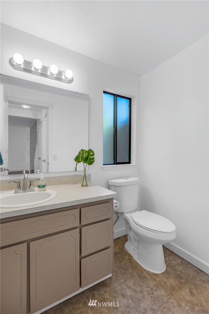 20512 Filbert Drive Bothell, WA 98012 - Photo 11 of 27 a bathroom with a toilet sink and mirror