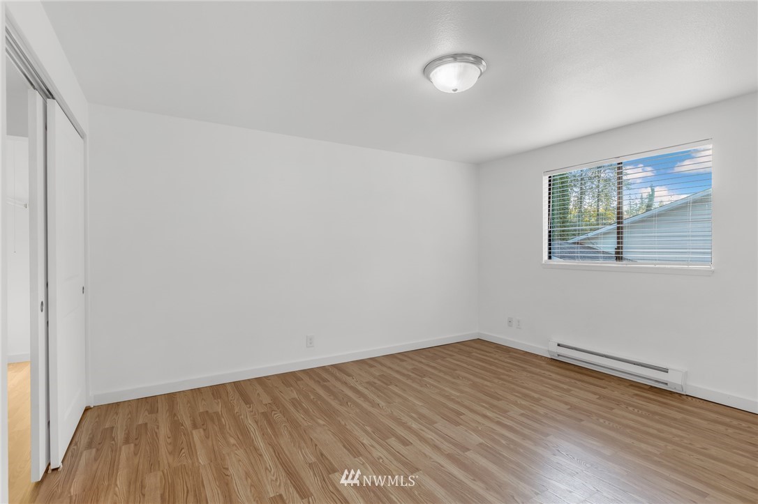 20512 Filbert Drive Bothell, WA 98012 - Photo 14 of 27 an empty room with wooden floor and windows