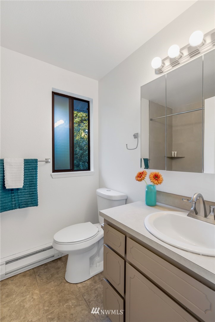 20512 Filbert Drive Bothell, WA 98012 - Photo 16 of 27 a bathroom with a sink a toilet and mirror
