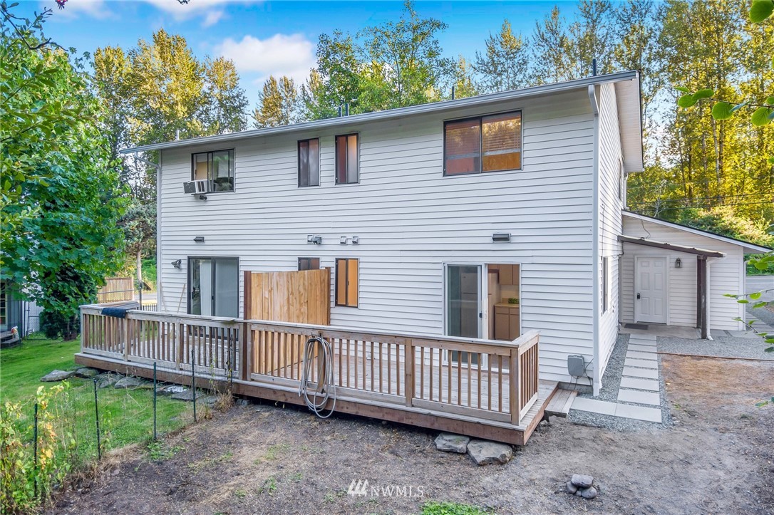20512 Filbert Drive Bothell, WA 98012 - Photo 20 of 27 a view of a house with a wooden deck and a yard