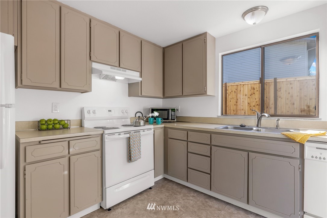 20512 Filbert Drive Bothell, WA 98012 - Photo 7 of 27 a kitchen with sink cabinets and window