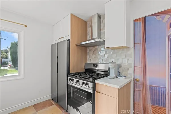 a kitchen with a stove and a refrigerator