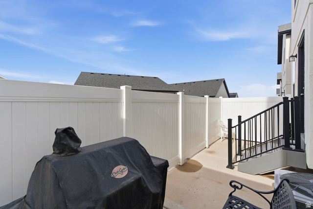 3808 Galatia Road Magna, UT 84044 - Photo 40 of 59 Private patio area with concrete flooring, framed by a white privacy fence