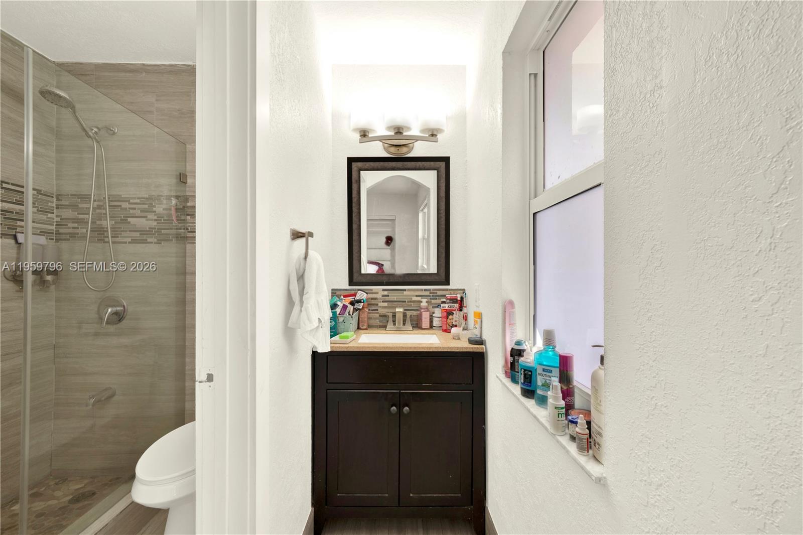 14600 Southwest 124th Place Miami, FL 33186 - Photo 12 of 34 a bathroom with a sink a toilet and shower