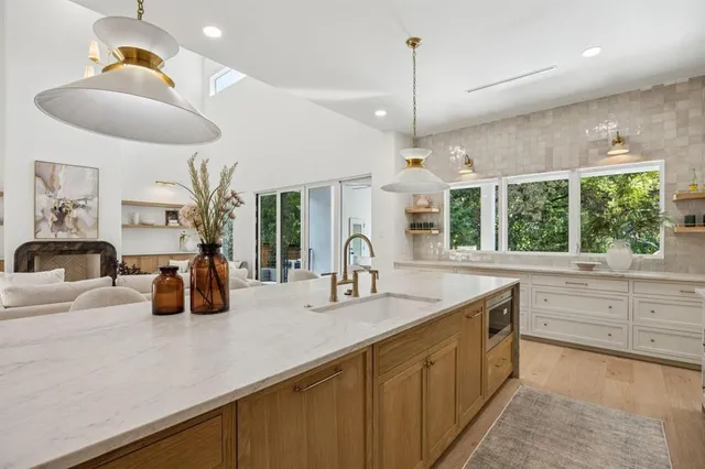 a kitchen with counter top space and windows
