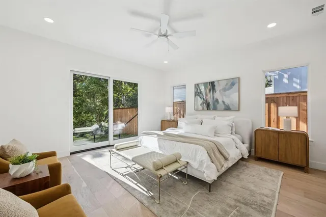 a spacious bedroom with a bed and glass window