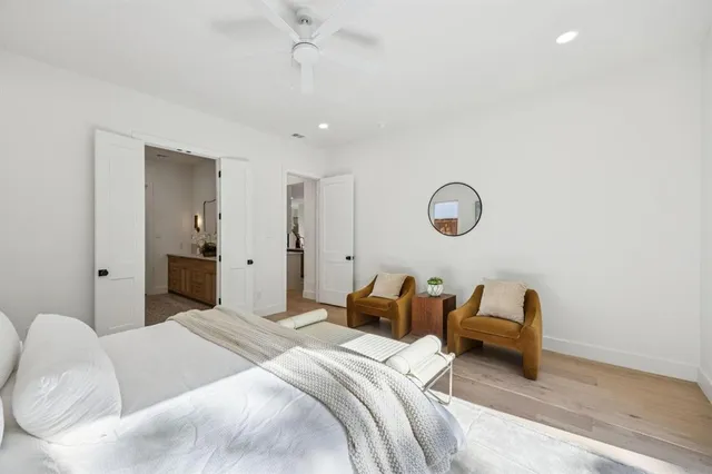 a bedroom with bed and a chandelier