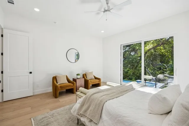 a bedroom with bed and a large window