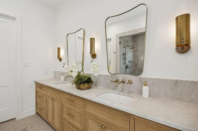a bathroom with a double vanity sink and a mirror