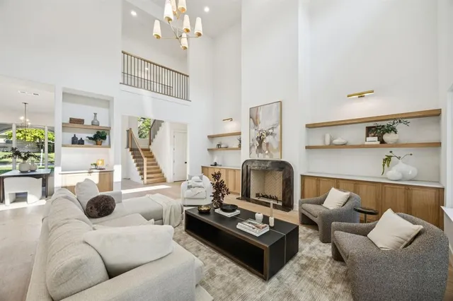 a living room with furniture and a chandelier