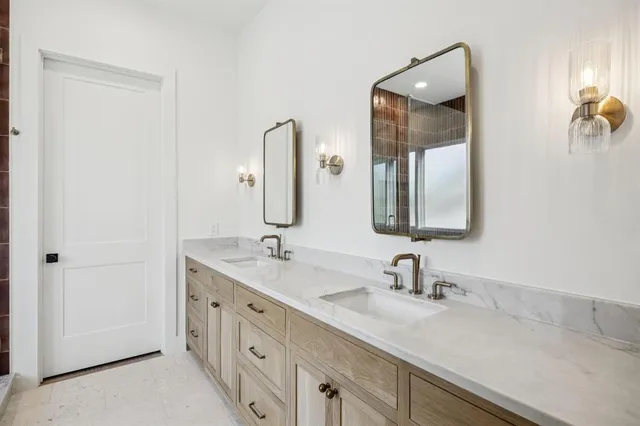 a bathroom with a double vanity sink and a mirror