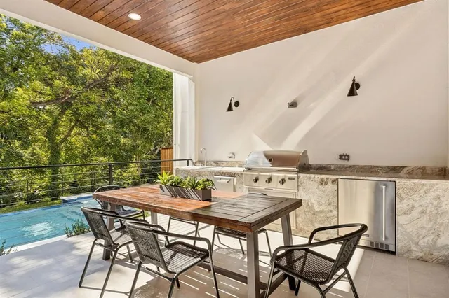 a view of an outside dining space with furniture