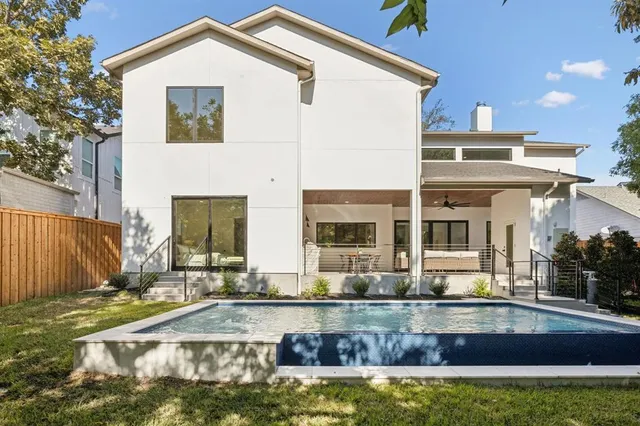a view of a house with swimming pool and sitting area