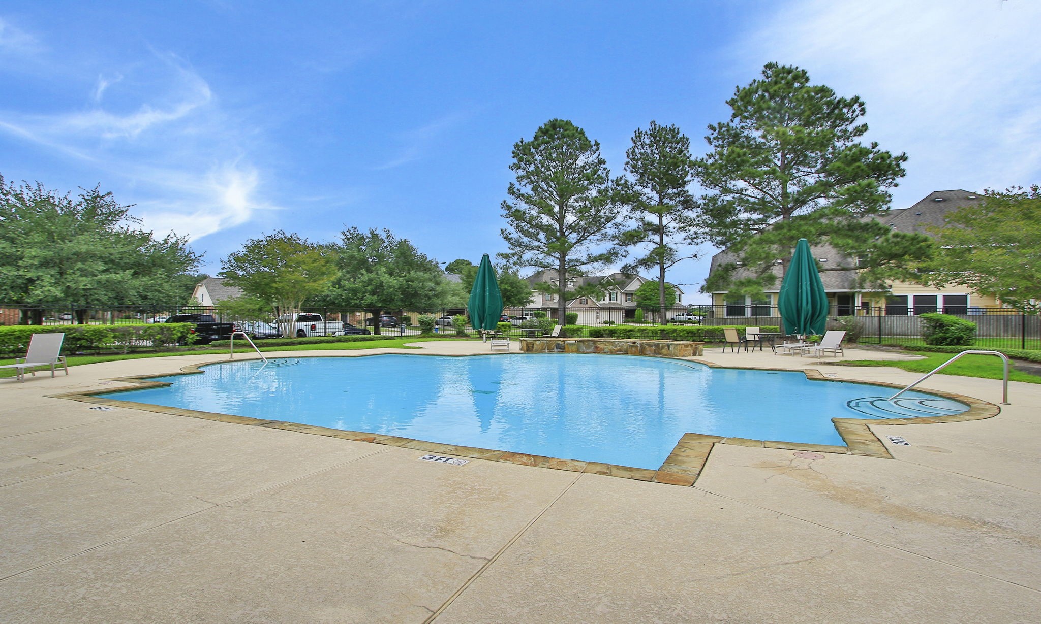 10516 Primo Place Spring, TX 77379 - Photo 23 of 34 Full fenced with wrought iron for safety. Nice patio umbrellas, too for those seeking shade.