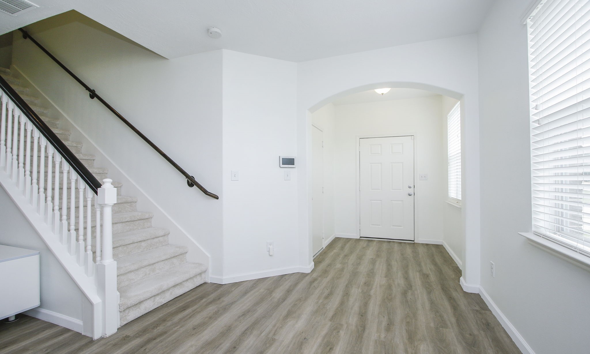 10516 Primo Place Spring, TX 77379 - Photo 5 of 34 Spacious entry foyer with windows. Stairs offer neutral carpet.