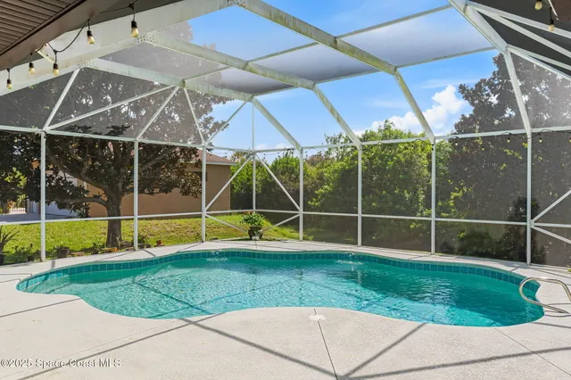 an aerial view of house with yard and ocean view