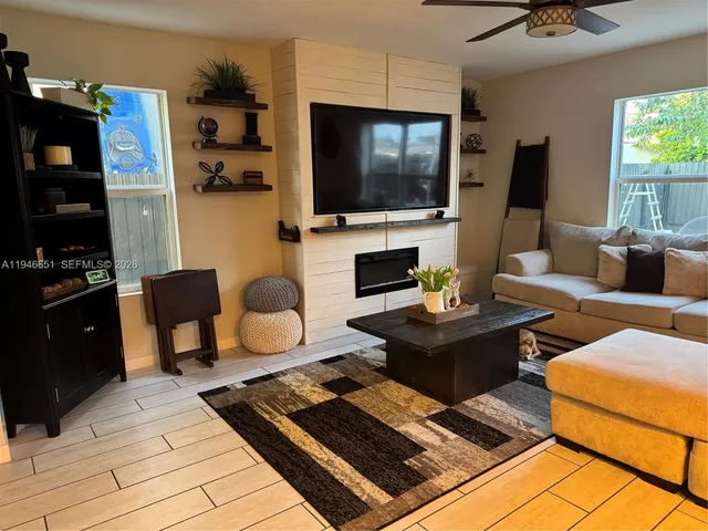 a living room with furniture and a flat screen tv