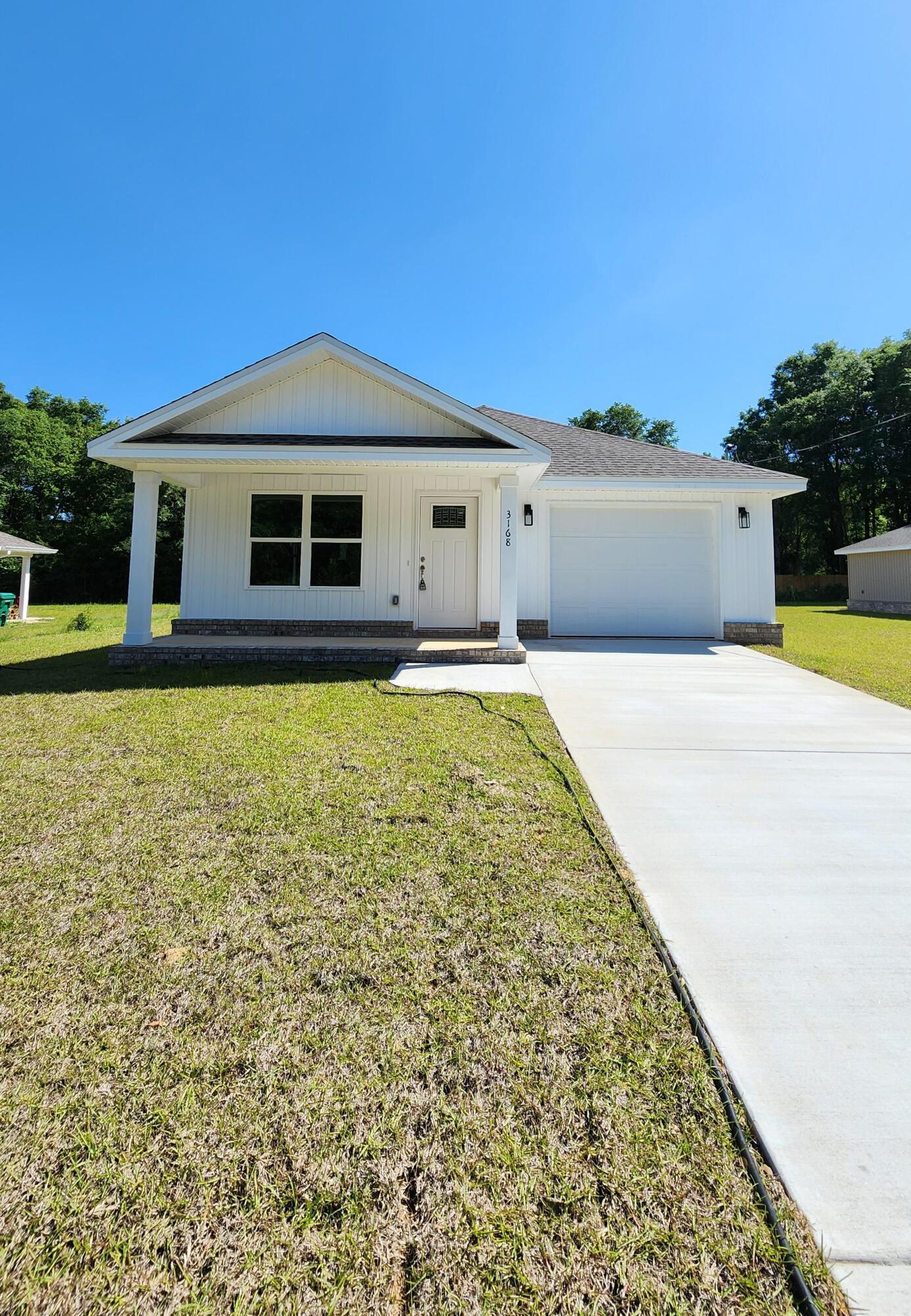 3168 Main Street Crestview, FL 32539 - Photo 1 of 18 a front view of a house with a yard