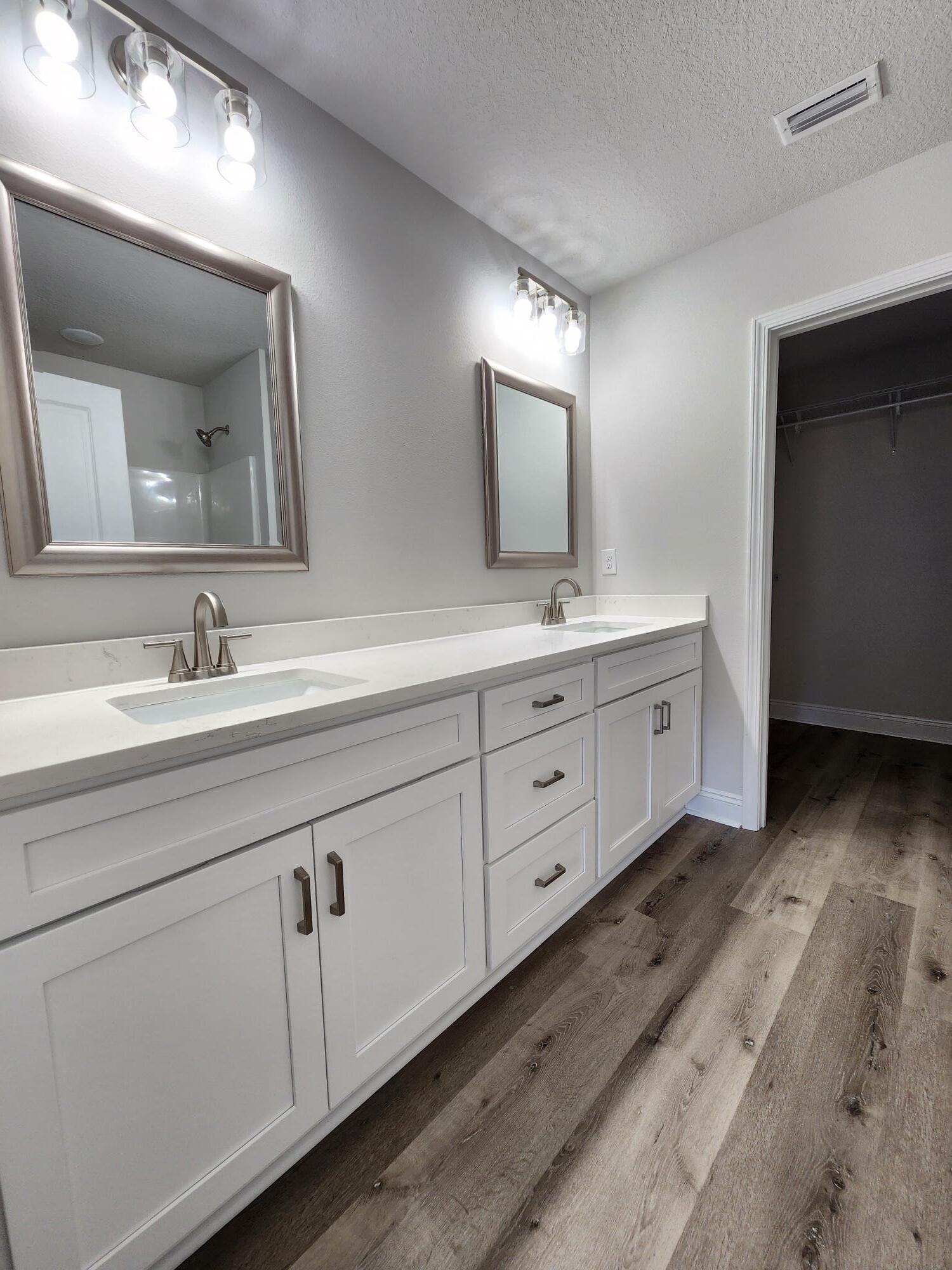 3168 Main Street Crestview, FL 32539 - Photo 11 of 18 a bathroom with a double vanity sink and mirror