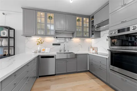 a kitchen with a sink cabinets and window