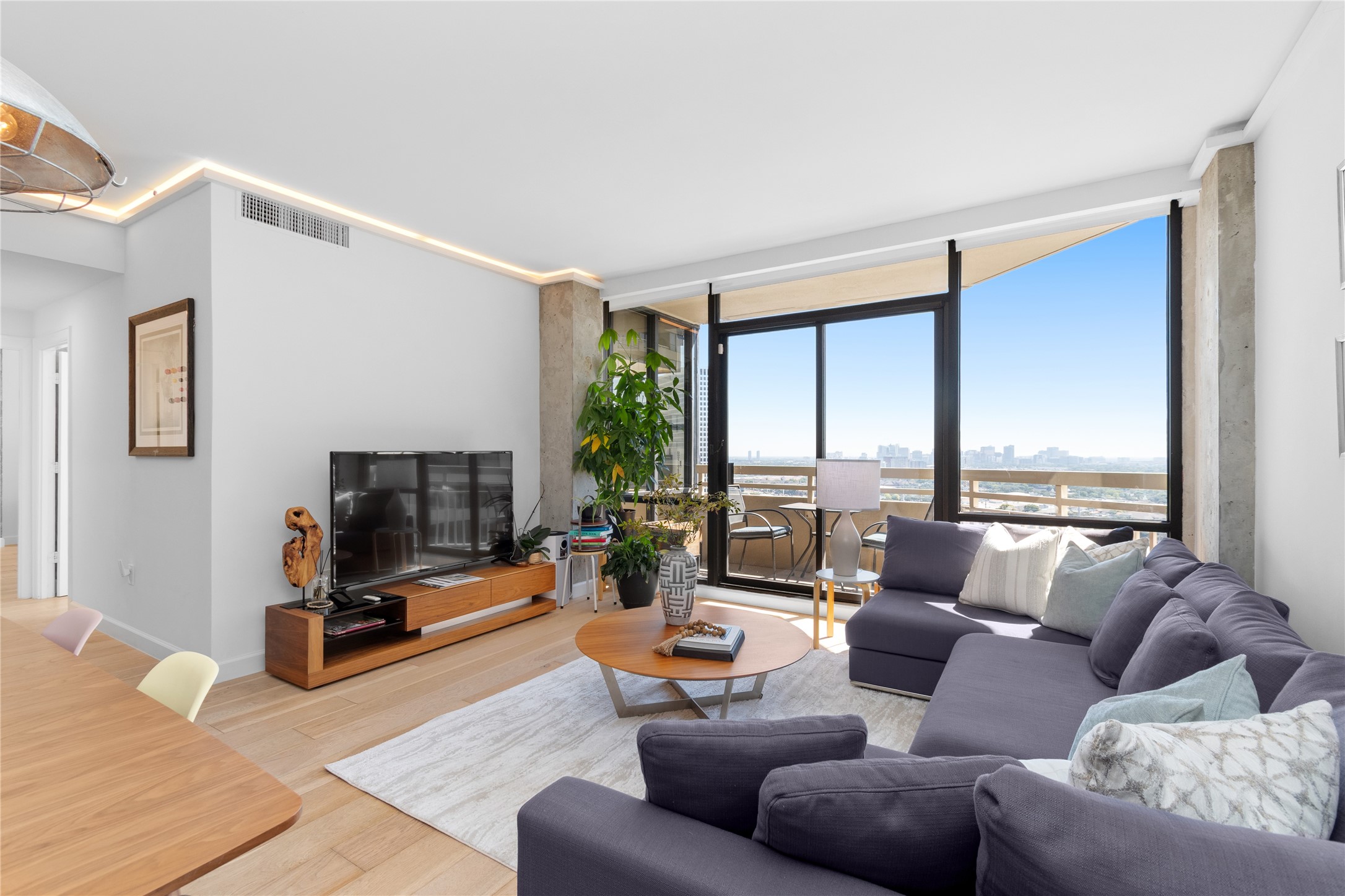 14 Greenway Plaza, Unit 23N Houston, TX 77046 - Photo 10 of 26 a living room with furniture and a flat screen tv