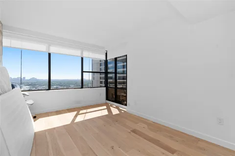 a bedroom with a large bed and a large window