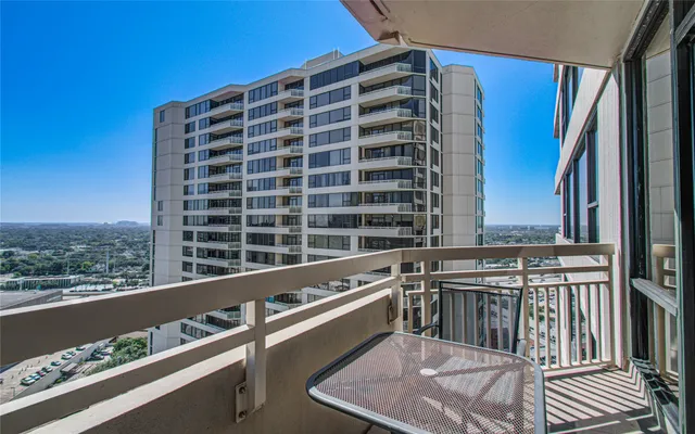 a balcony with table and chairs