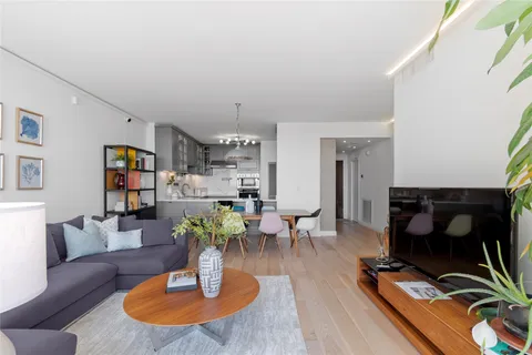 a kitchen with kitchen island a counter top space cabinets and stainless steel appliances