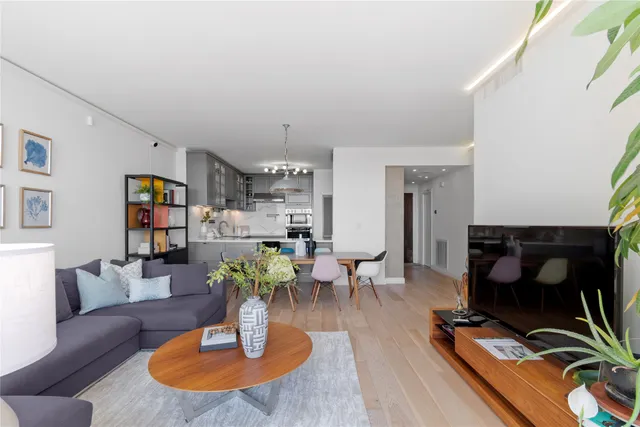 a kitchen with kitchen island a counter top space cabinets and stainless steel appliances