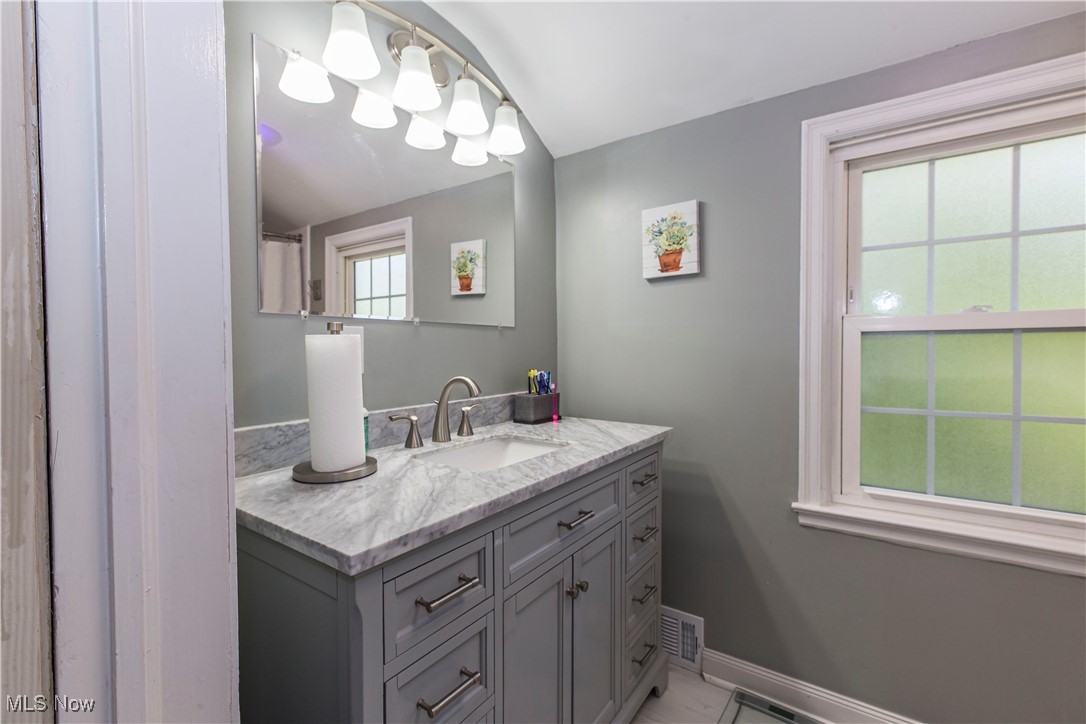 2113 Stabler Road Akron, OH 44313 - Photo 28 of 39 Recently Remodeled Full bathroom with vanity and baseboards