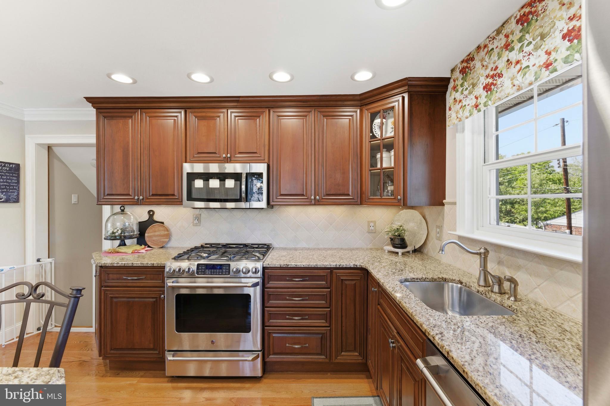 447 Maddock Road Springfield, PA 19064 - Photo 13 of 42 a kitchen with granite countertop a stove sink and cabinets