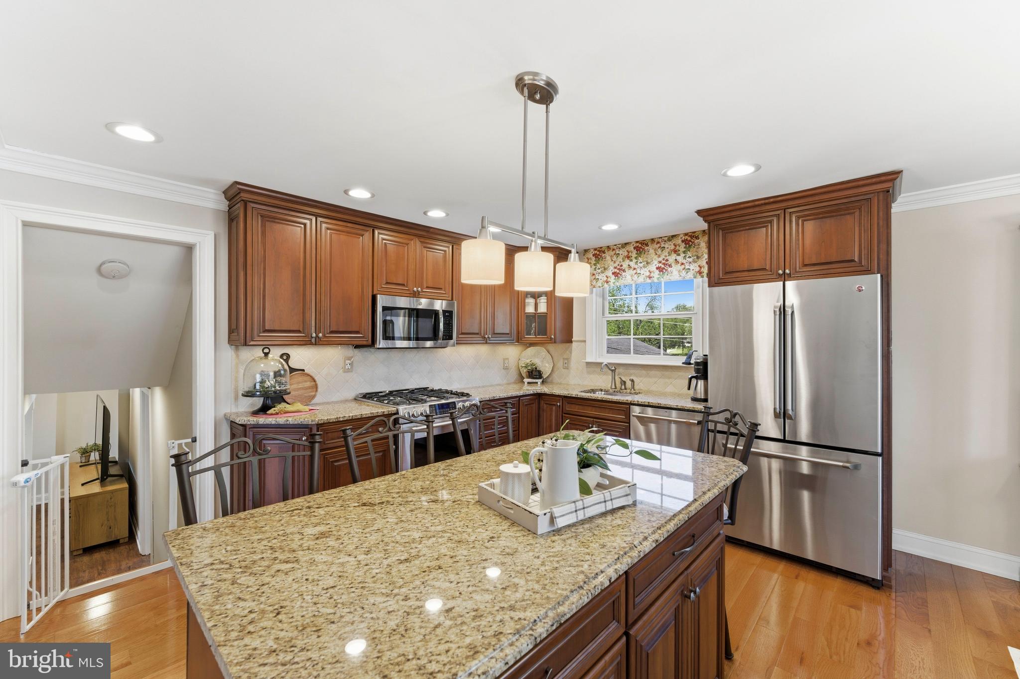 447 Maddock Road Springfield, PA 19064 - Photo 16 of 42 a kitchen with stainless steel appliances granite countertop a sink stove and refrigerator