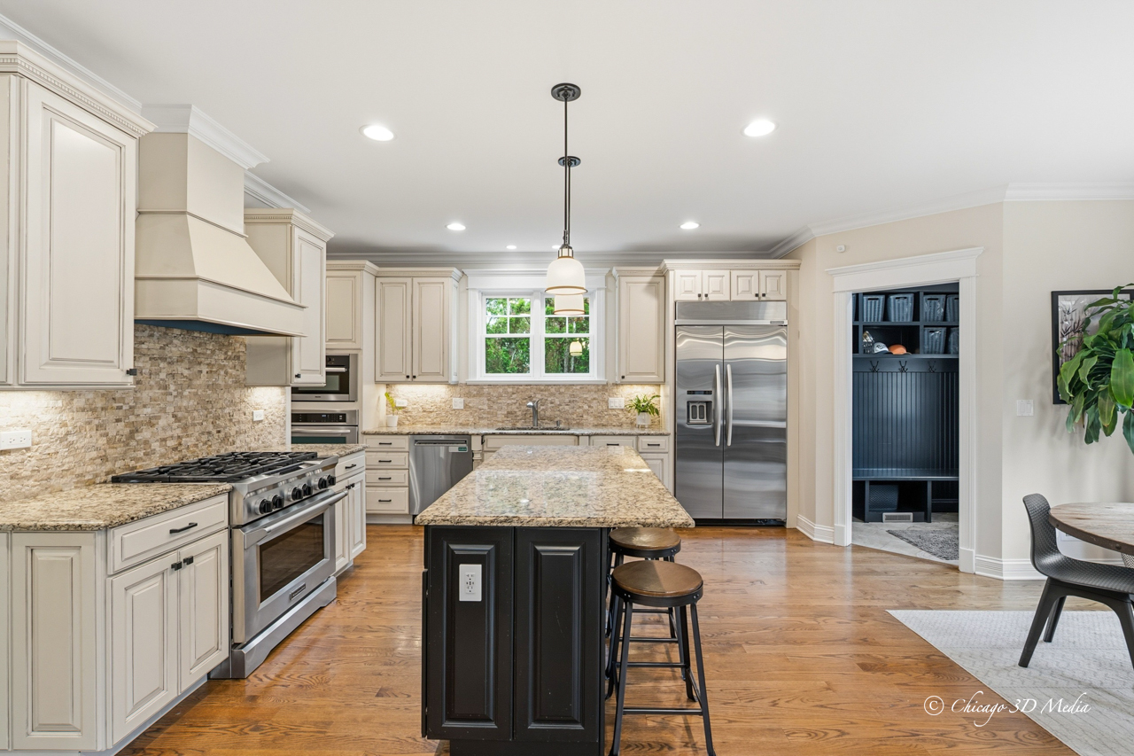 306 17th Street Wilmette, IL 60091 - Photo 11 of 48 a kitchen with stainless steel appliances kitchen island granite countertop a stove a sink and a refrigerator