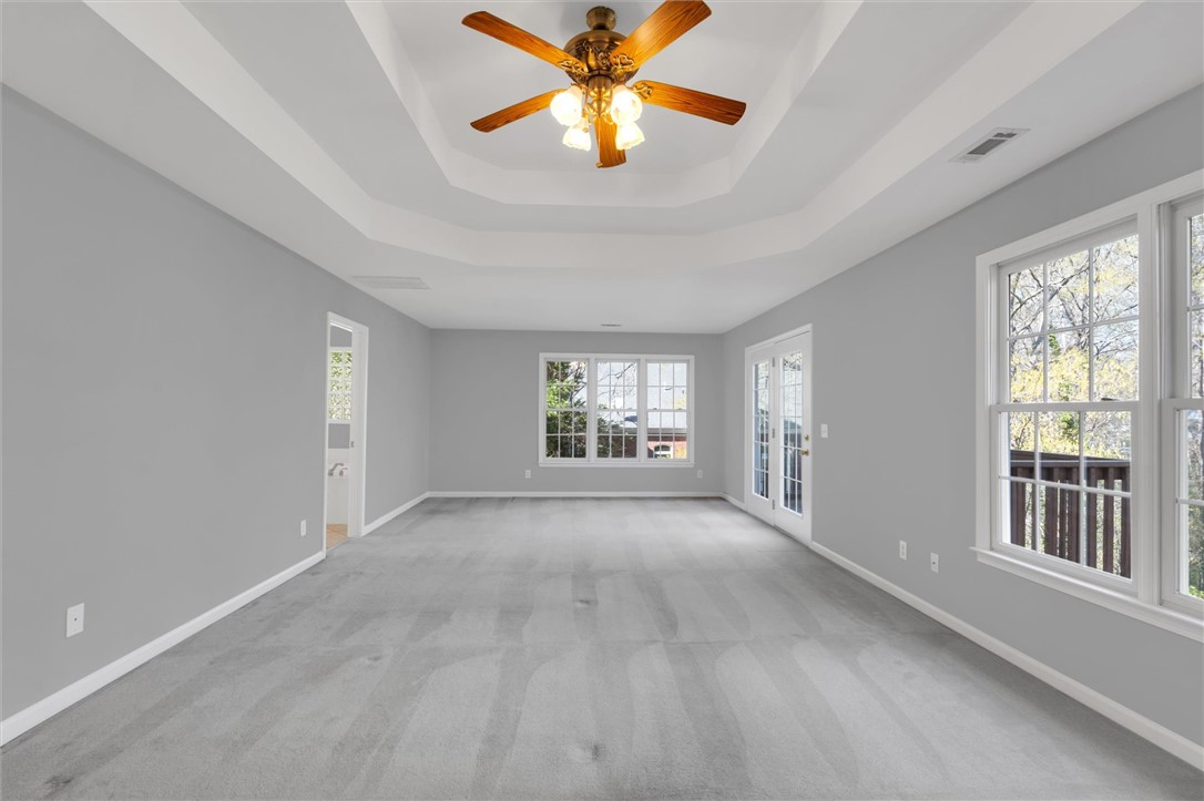 204 Red Maple Way Clemson, SC 29631 - Photo 25 of 48 This spacious primary bedroom offers ample light and private outdoor access.