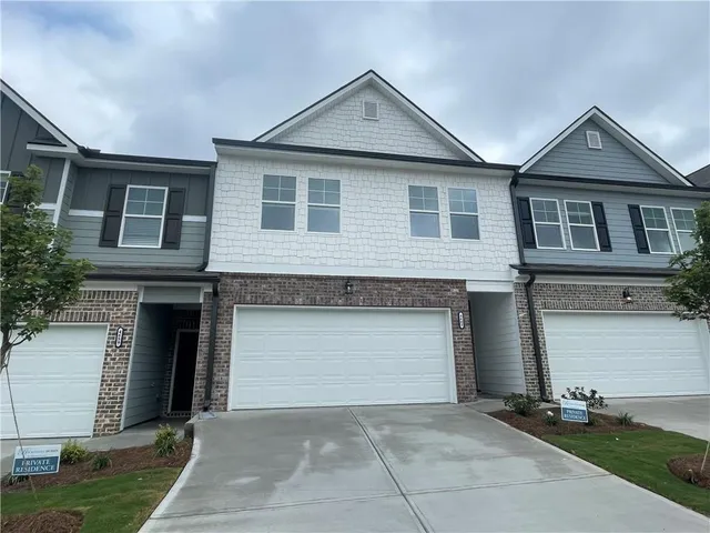 a front view of a house with garage