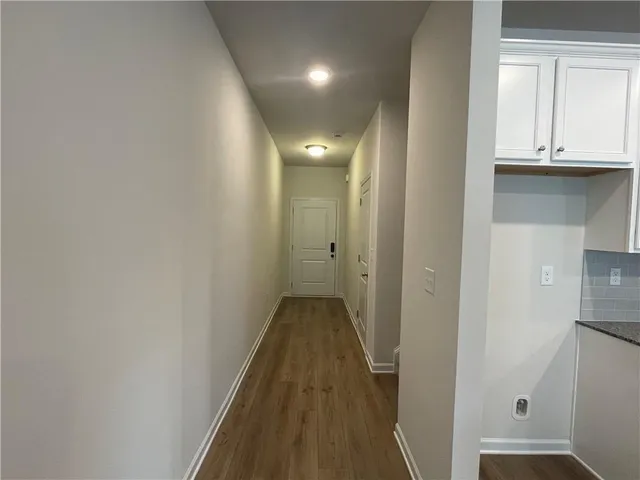 a view of a hallway with wooden floor