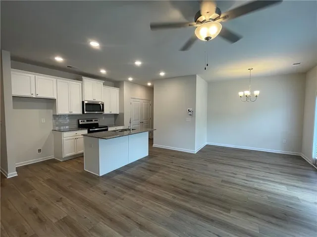 a view of kitchen with sink microwave and stove