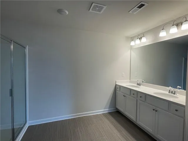 a bathroom with a double vanity sink and a mirror