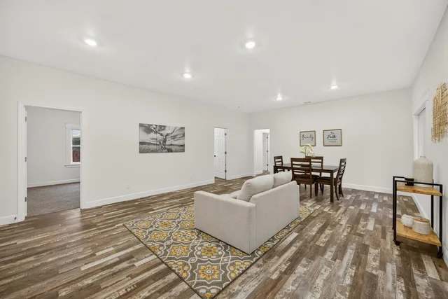 a view of a dining room with furniture and wooden floor