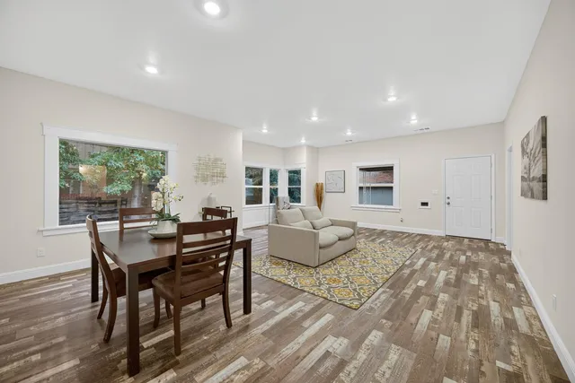 a living room with furniture and a floor to ceiling window
