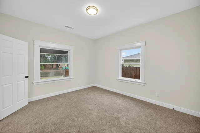 an empty room with windows and entrance