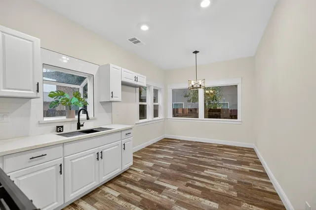 a kitchen with granite countertop a sink and a stove