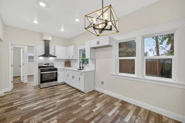 a kitchen with white cabinets and appliances