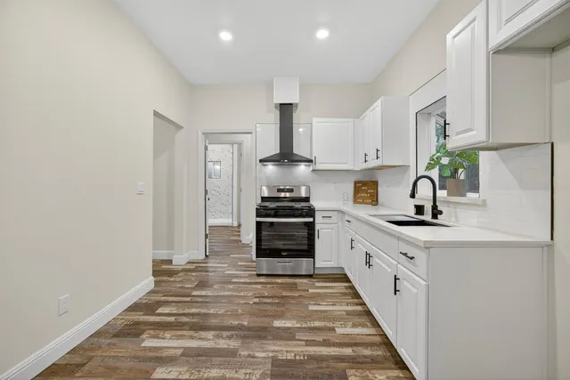 a kitchen with a stove and a potted plant