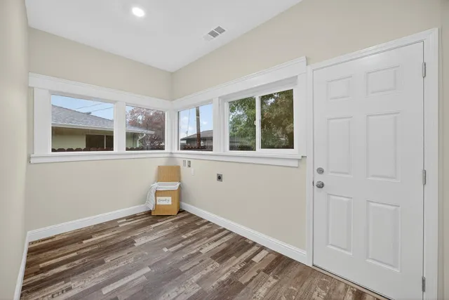 a view of a room with wooden floor and windows