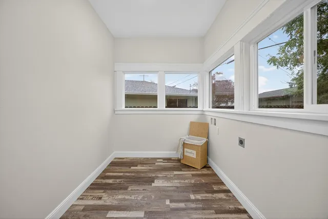 a bathroom with a toilet sink vanity granite and shower