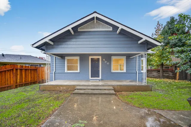 a view of front of house with a yard