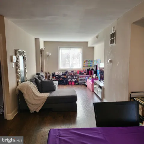 a bedroom with furniture and a large window