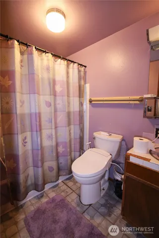 a bathroom with a toilet sink and shower