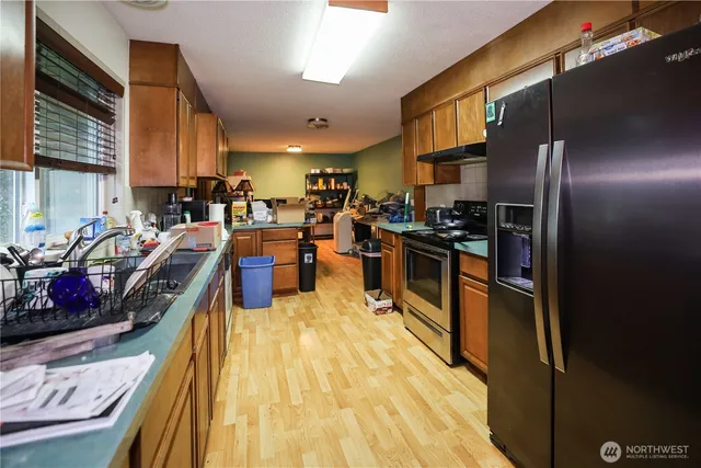 a view of a kitchen with stainless steel appliances lots of counter top space